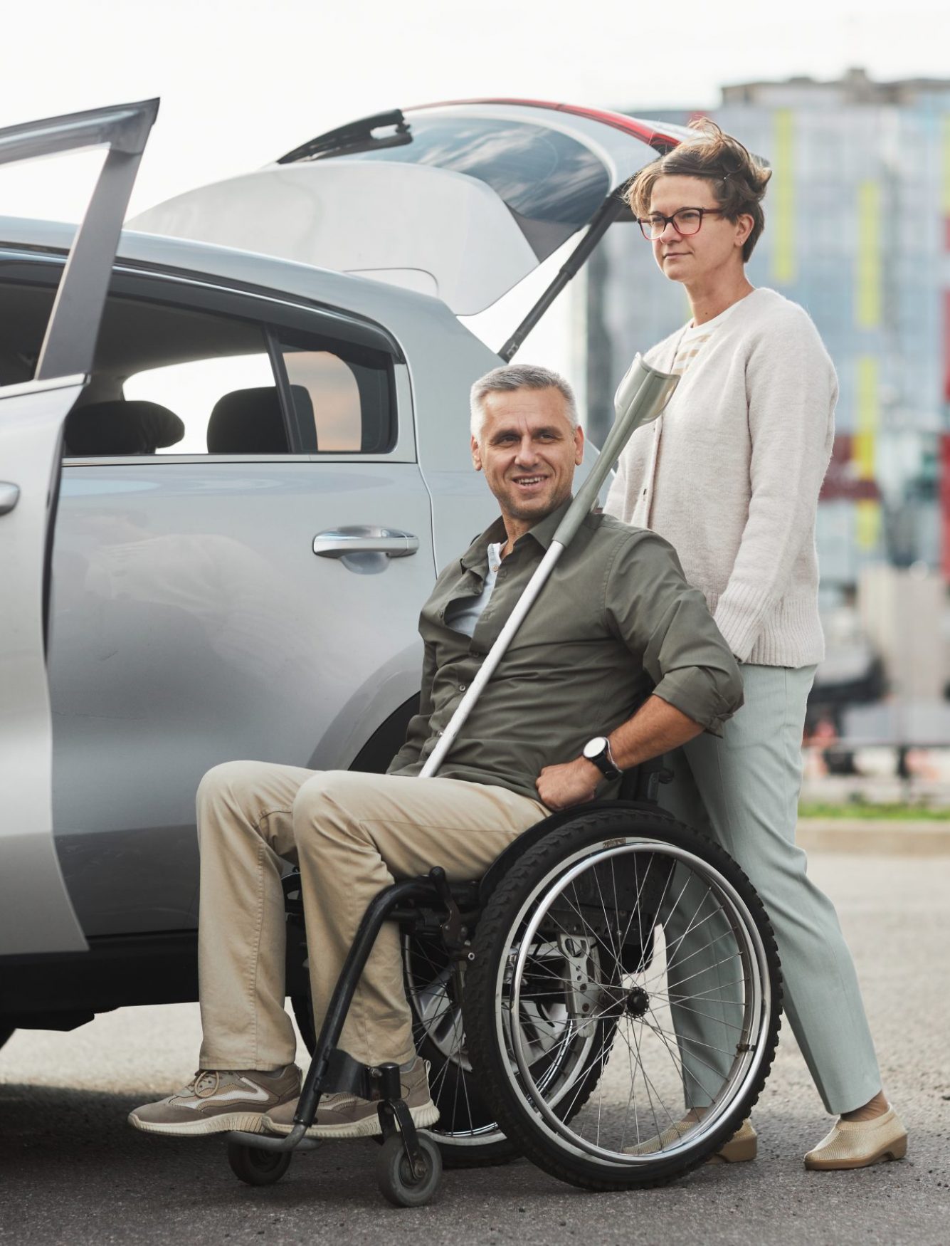 Smiling Driver with Man in Wheelchair by Car
